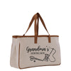 A beige canvas tote bag with the text "Grandma's Sewing Box" printed on it, along with illustrations of sewing-related items such as scissors and a spool of thread.