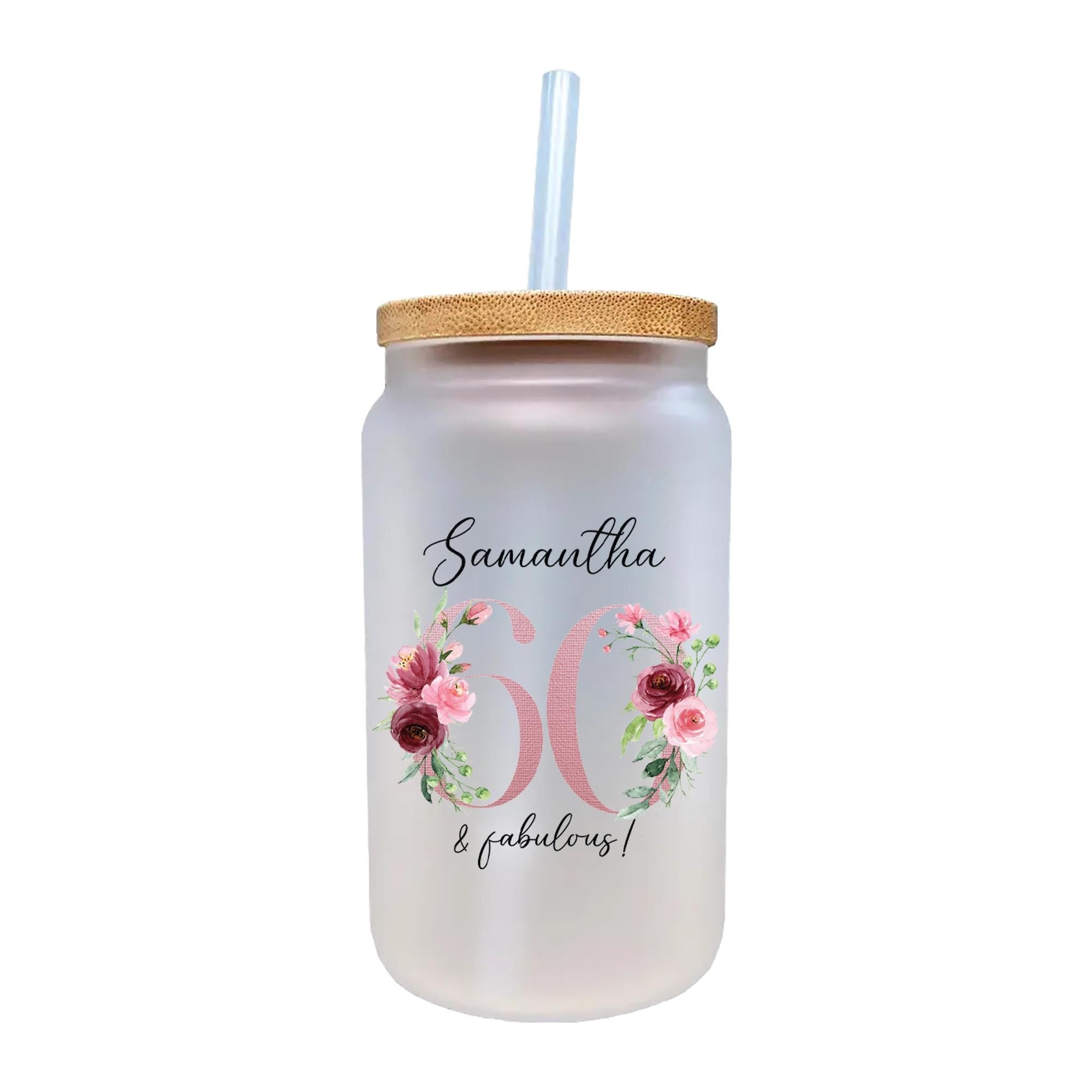 a white mason jar with pink flowers and a straw