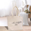a white tote bag sitting on top of a wooden floor