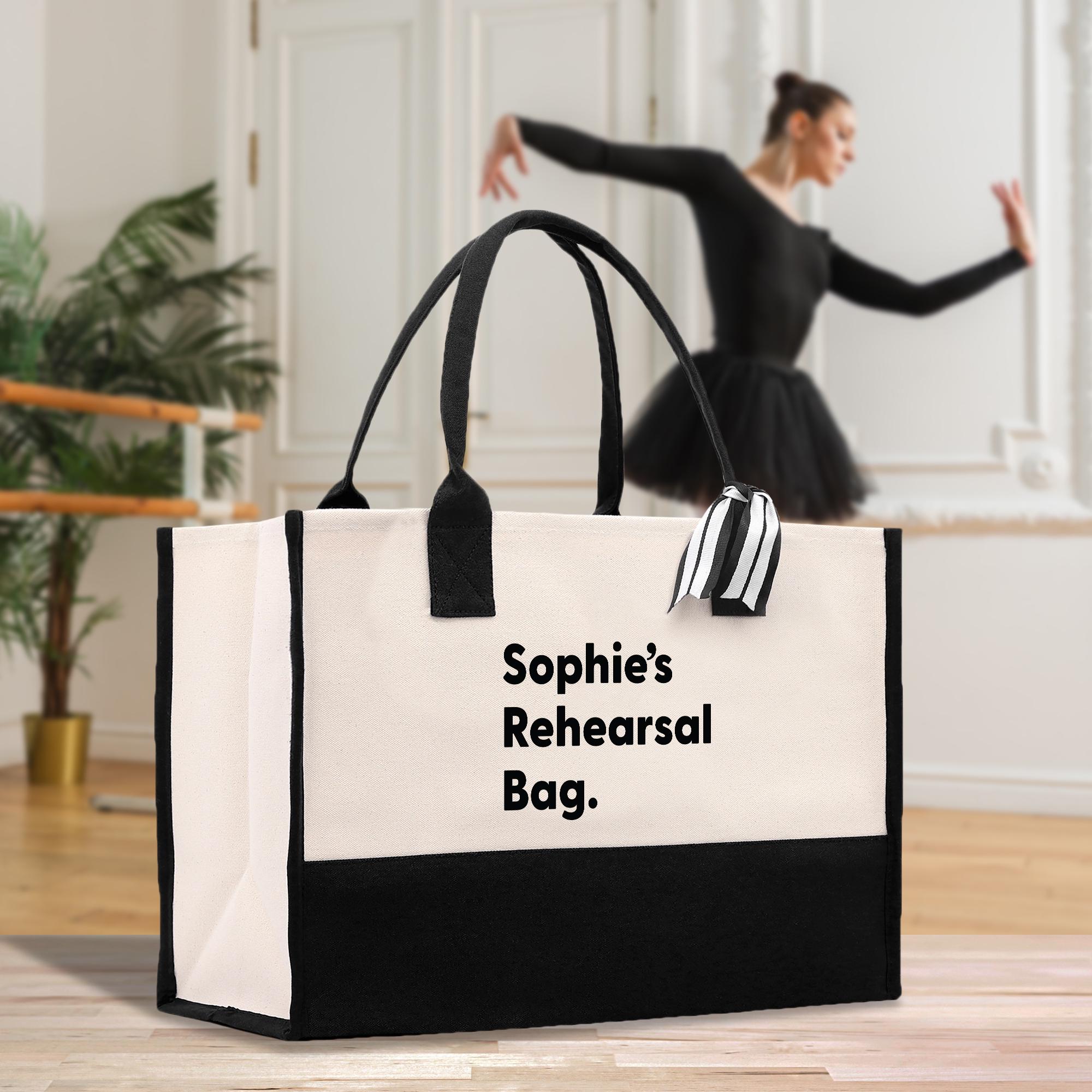 a woman in a black dress is dancing with a black and white bag