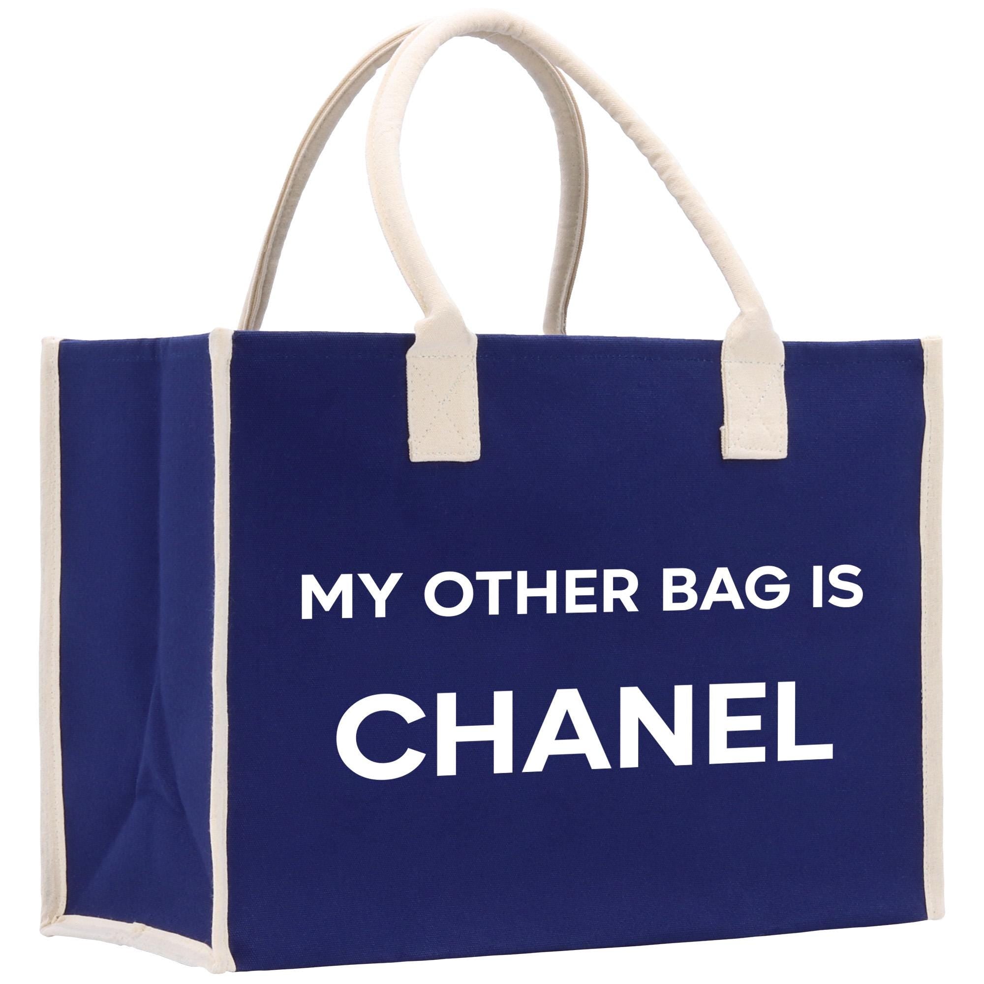 a blue bag with a white handle that says, my other bag is chanel