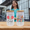 a woman standing next to a plastic cup with a straw in it