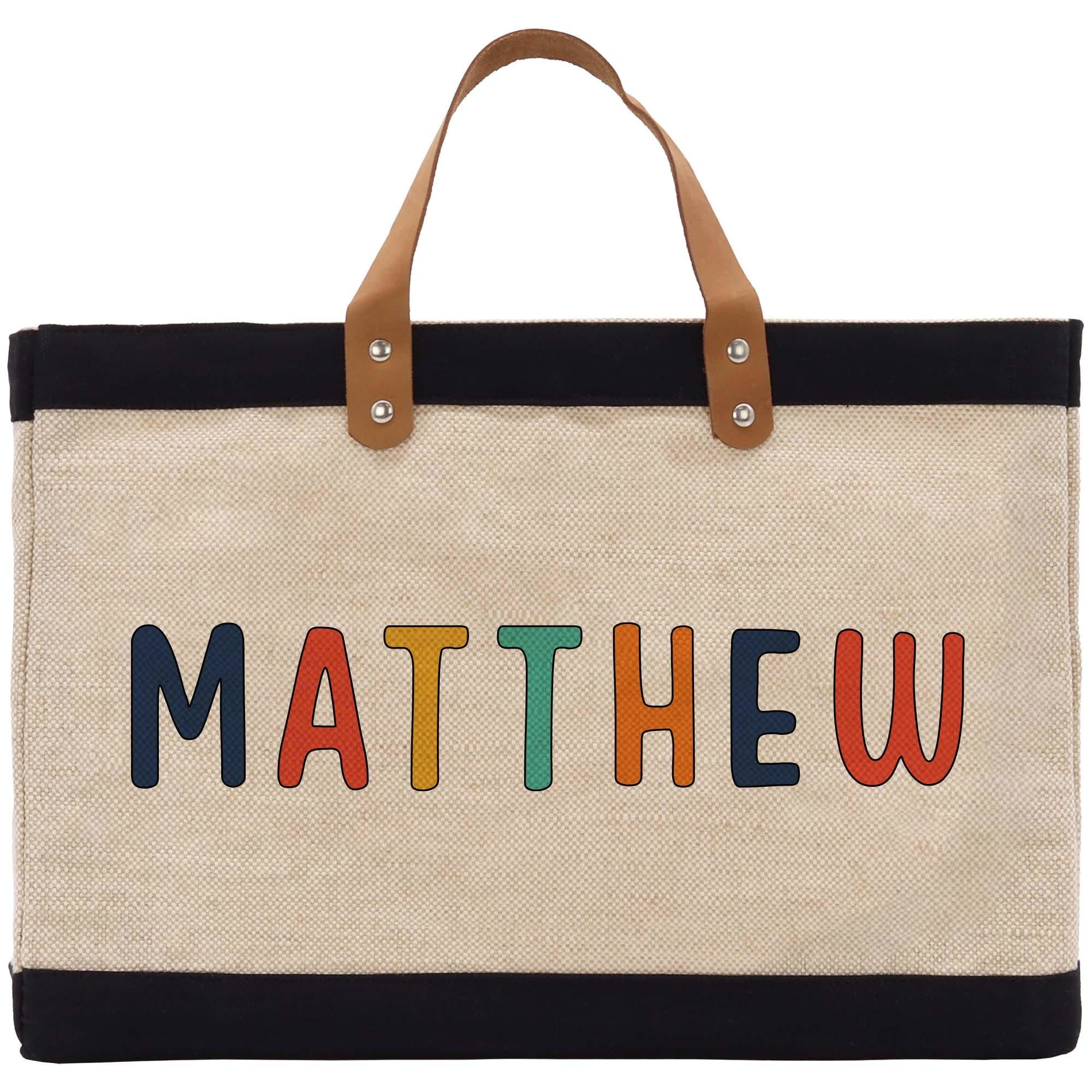 a canvas bag with the word mathew painted on it