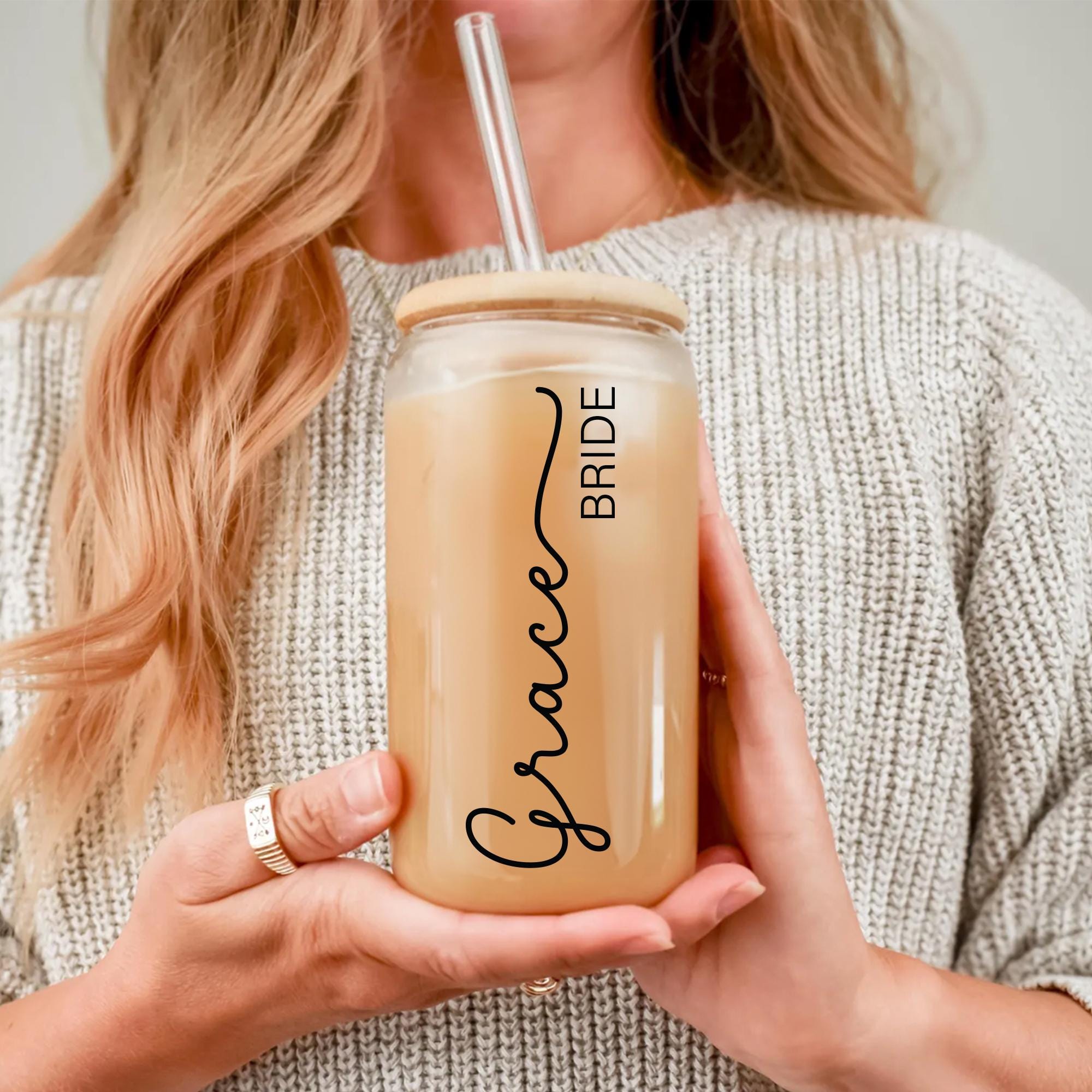 a woman holding a drink in her hands