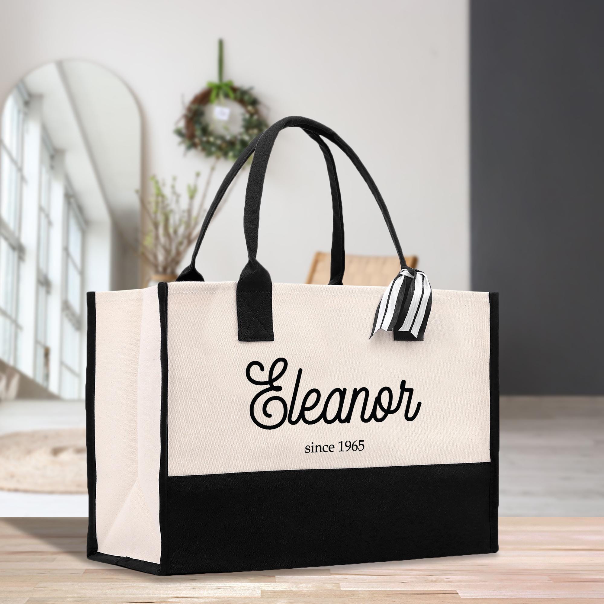a black and white tote bag sitting on a table