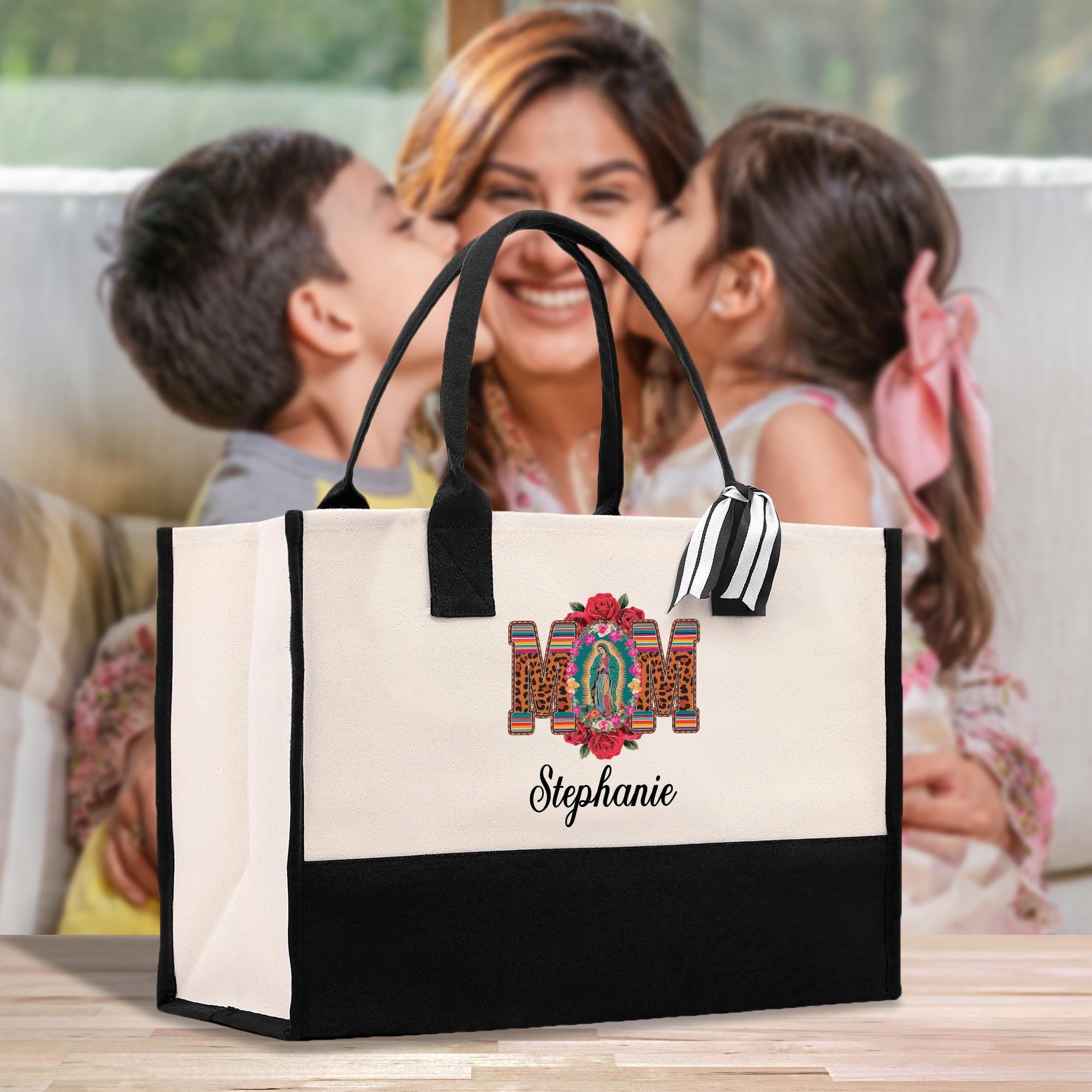a woman holding a child and kissing a bag