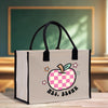 a shopping bag with a checkered apple on it