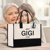 an older woman and young girl sitting in front of a bag that says best gig