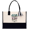 A beige tote bag with a black handle and a black and white striped ribbon tied around it. The bag has a printed message on it that says "Faith Hope Love Family" and "Williams Family 2020".
