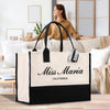 a woman sitting on a couch behind a white and black bag