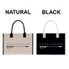 two bags, one natural and one black, both with the word "EQUESTRIAN" printed on them.