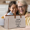 an older woman and a young girl sitting at a table with a bag