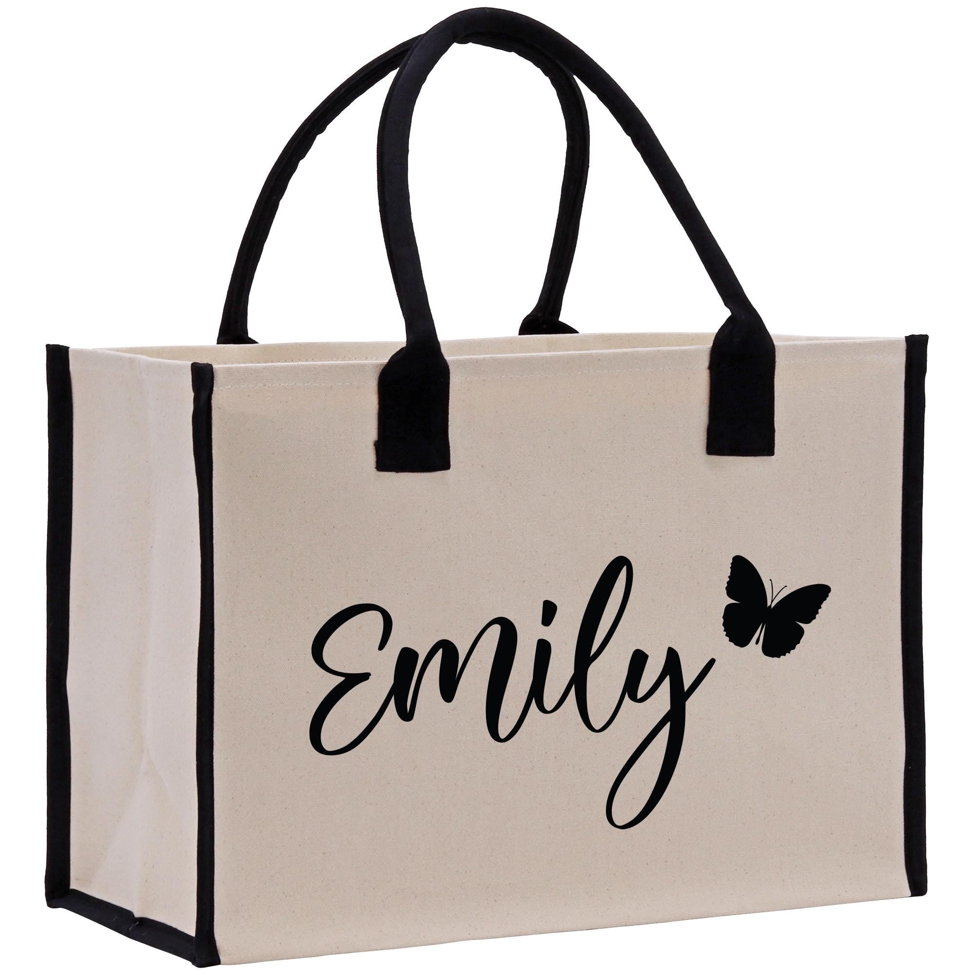 a white bag with a black handle and a butterfly on it