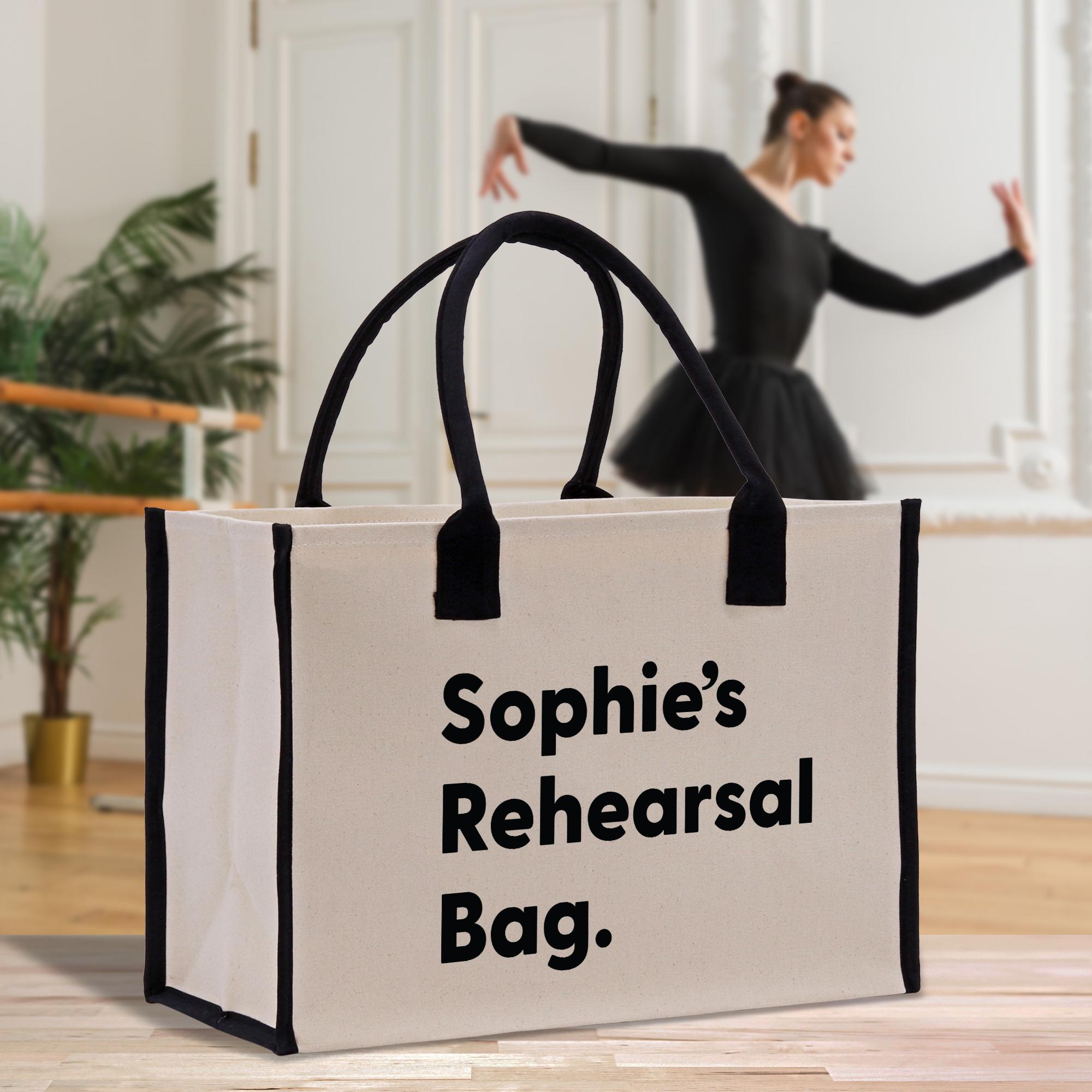 a woman in a black dress is dancing behind a white bag