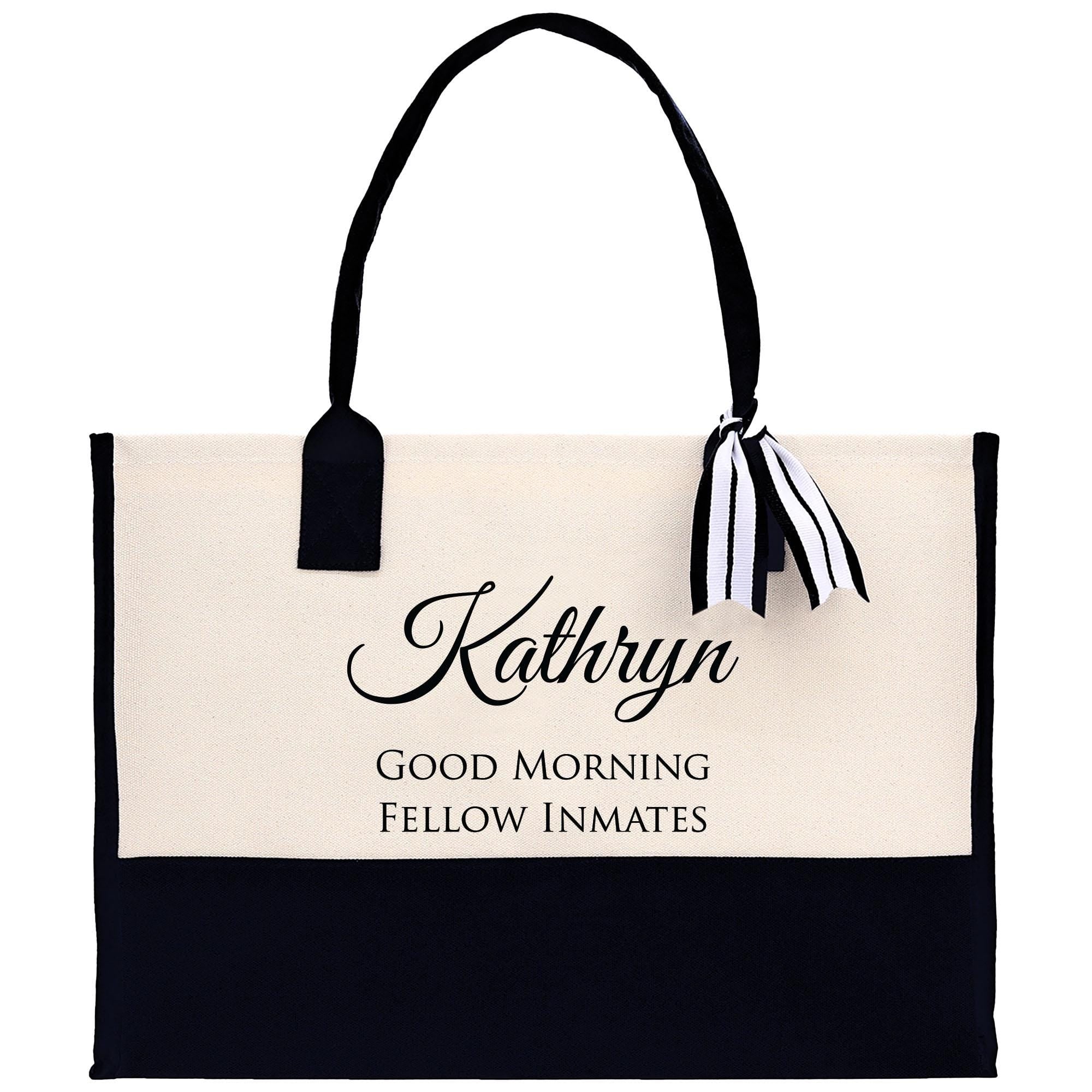 a black and white tote bag with a ribbon on it