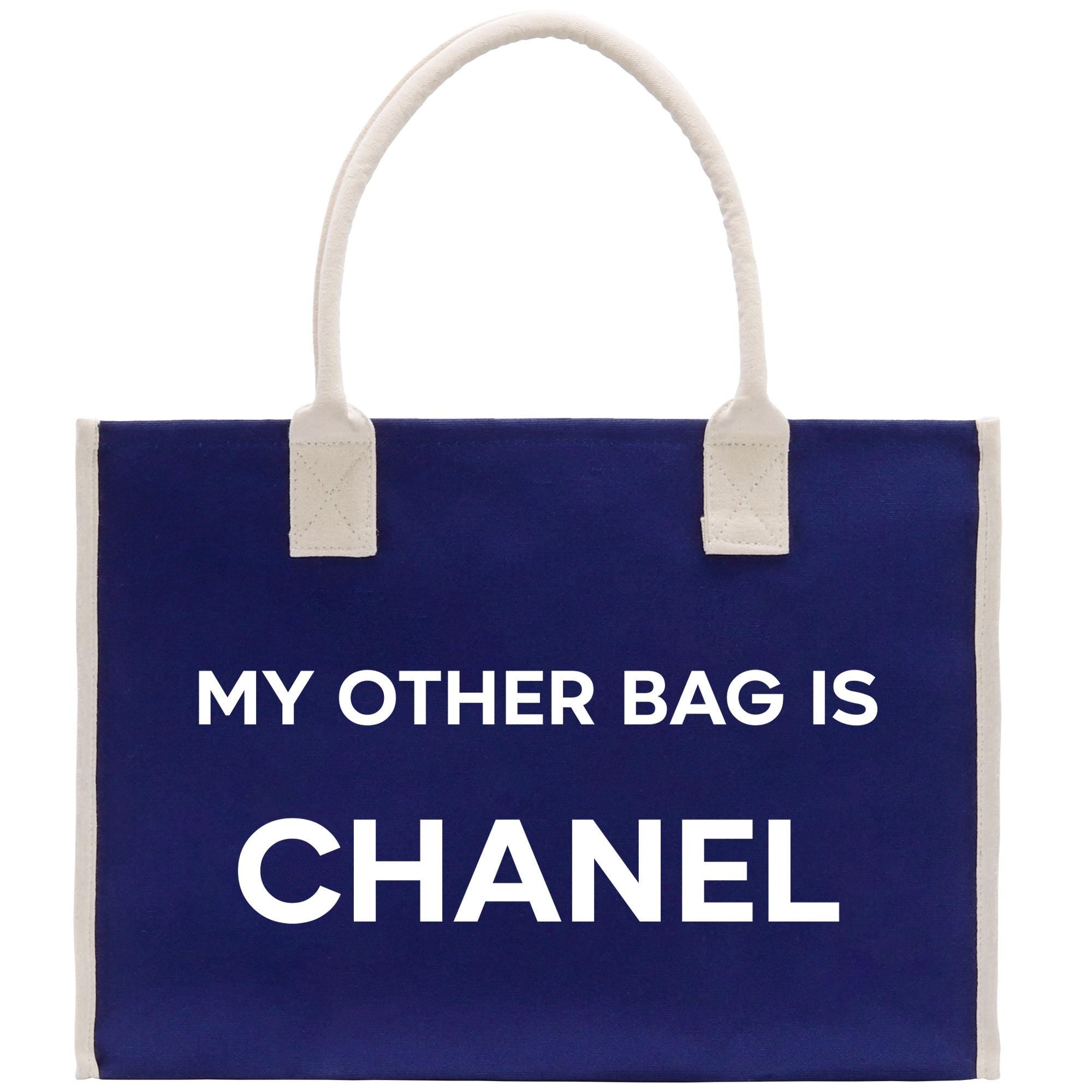 a blue bag with a white handle that says, my other bag is chanel