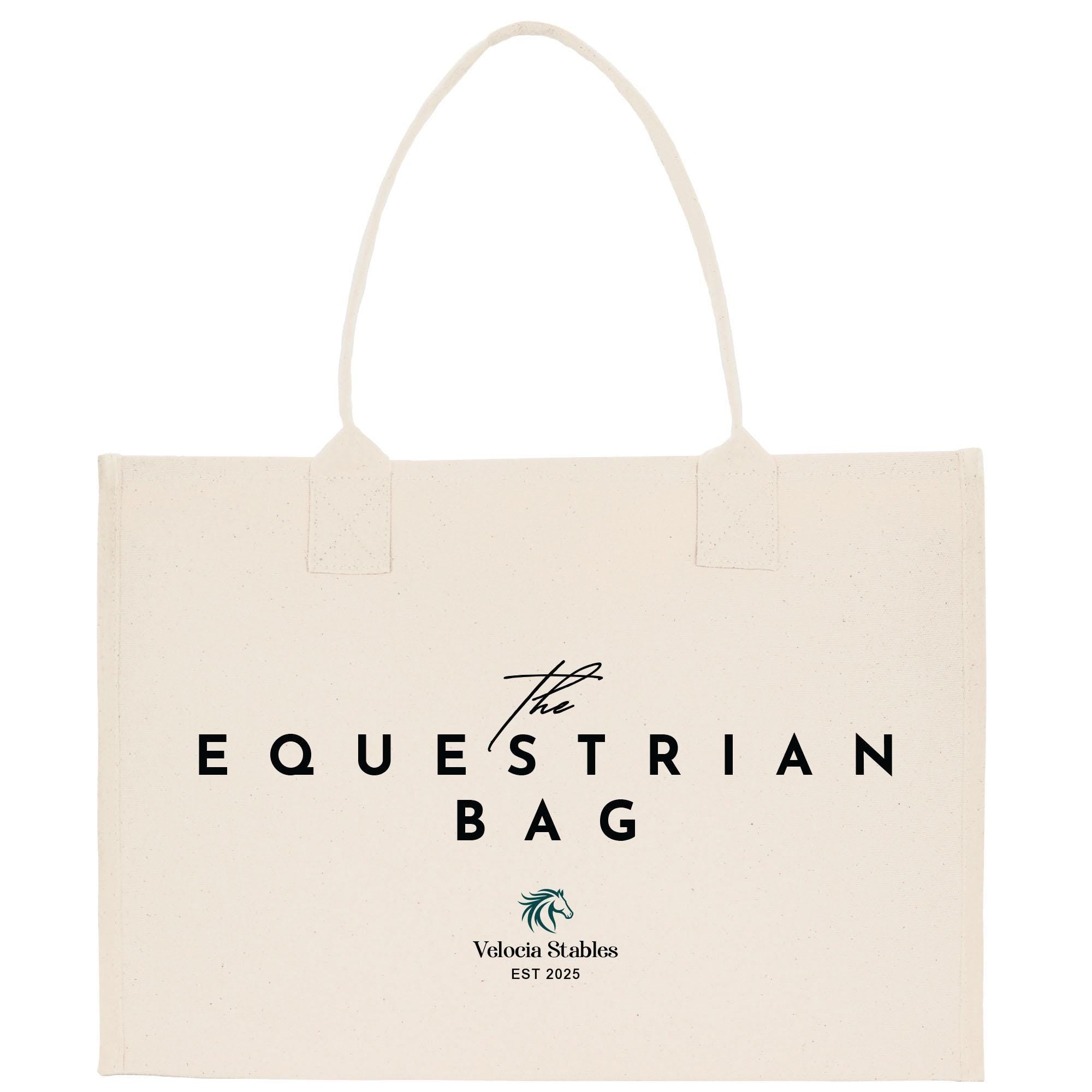 a beige canvas tote bag with the text &quot;The Equestrian Bag&quot; printed on it.