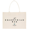 a beige canvas tote bag with the text "The Equestrian Bag" printed on it.