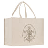 A beige canvas tote bag with a decorative floral design and text printed on it.
