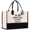 A large tote bag with a black and white color scheme. The bag has a handle and a strap, and it features text that reads "No. 50 SHAD & ALEX ST-BARTS VINTAGE 1975".