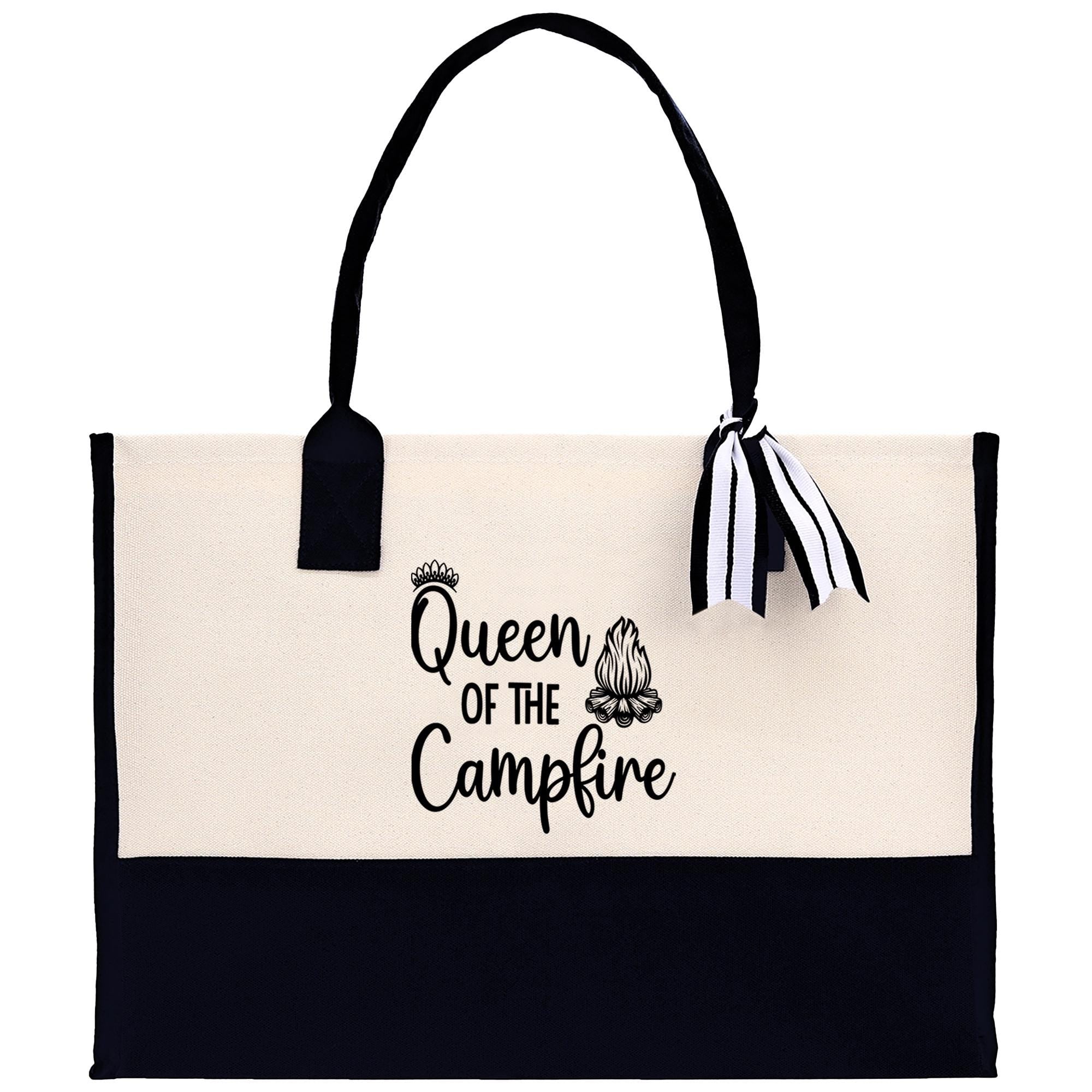 A beige tote bag with the text "Queen of the Campfire" printed on it, along with a crown icon and a campfire graphic.