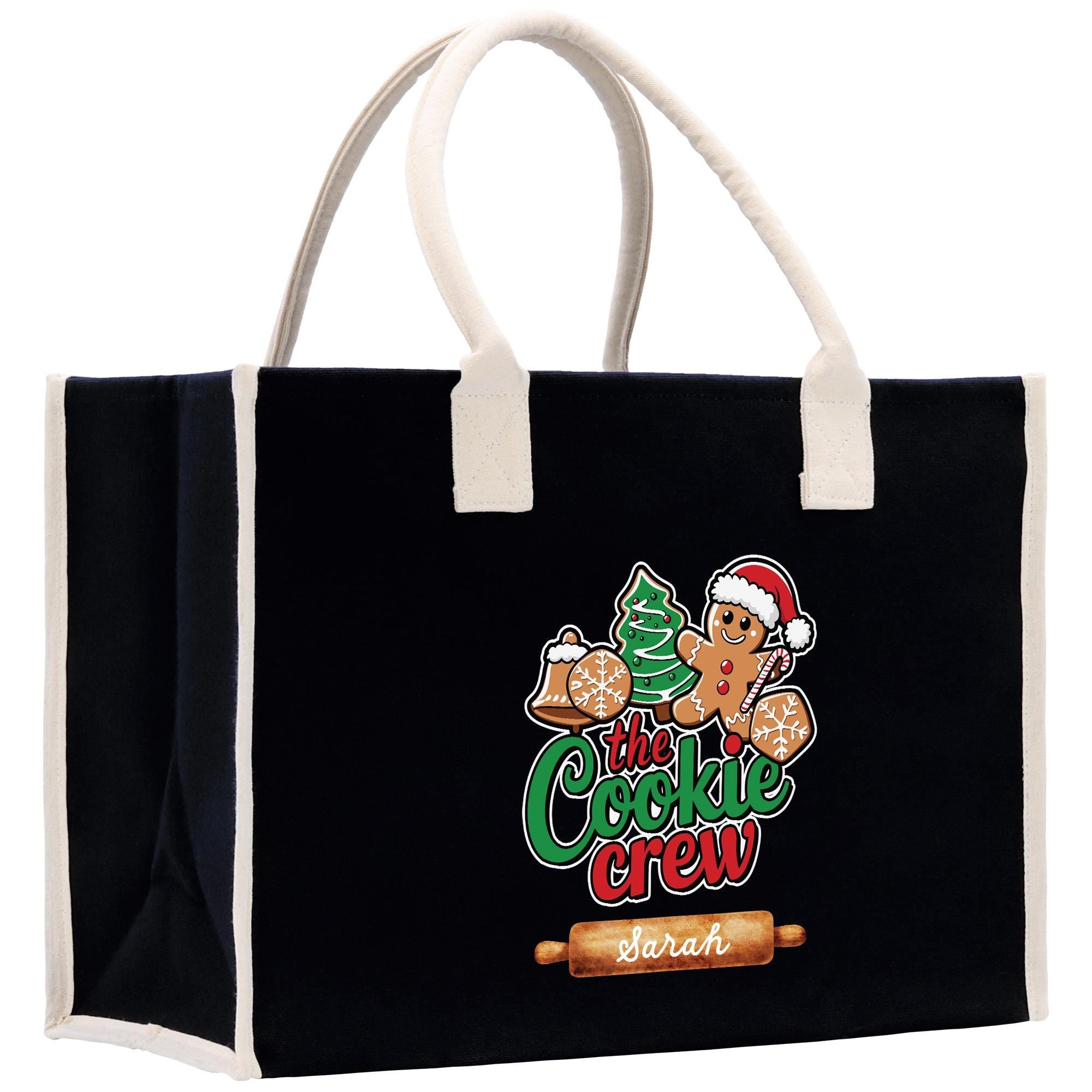 A black tote bag with a white handle and a graphic of a gingerbread man wearing a Santa hat.