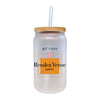 a glass jar with a straw inside of it