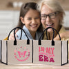an older woman and a young girl are looking at a shopping bag