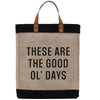 A beige tote bag with black trim and leather handles, displaying the text "These are the good ol' days" in a bold, black font.