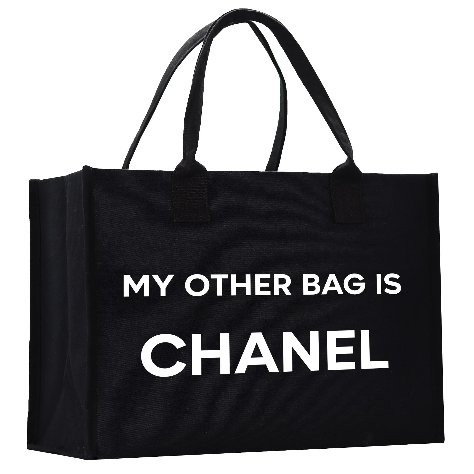 a black tote bag with a white print that says, my other bag is