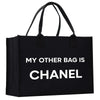 a black tote bag with a white print that says, my other bag is