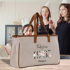 two women standing behind a bag with a date printed on it