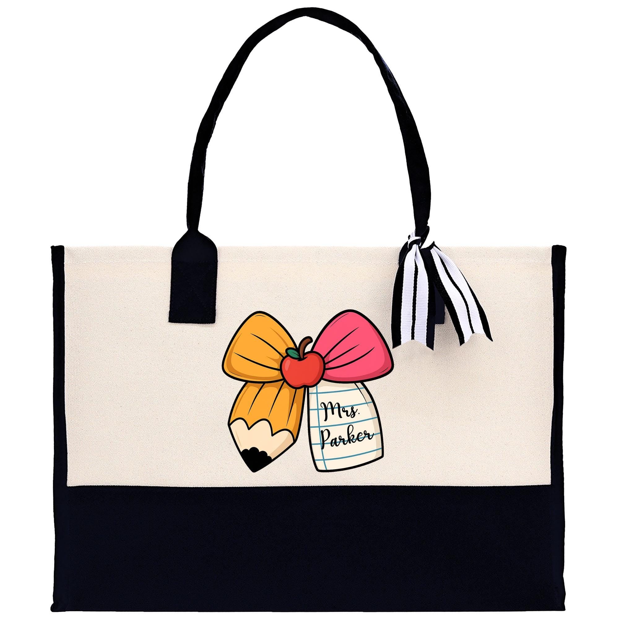 a white and black bag with a pink bow on it