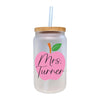 a glass jar with a straw and a pink apple on it