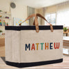 a canvas bag with the word mathew painted on it