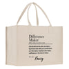 A beige tote bag with a printed definition of a " Difference Maker" on it.