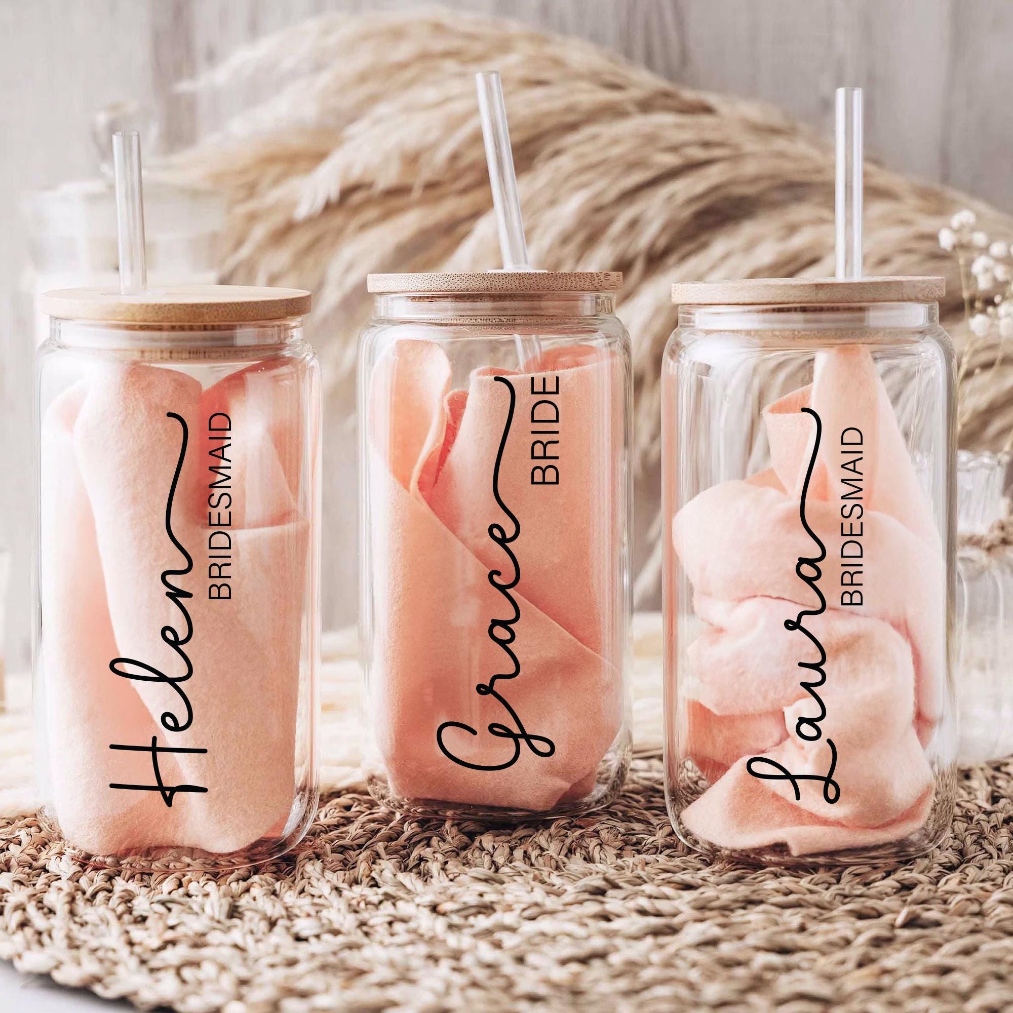 three personalized mason jars with straws in them