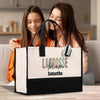 two girls sitting on a couch looking at a bag