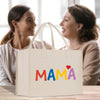 two women sitting at a table with a shopping bag