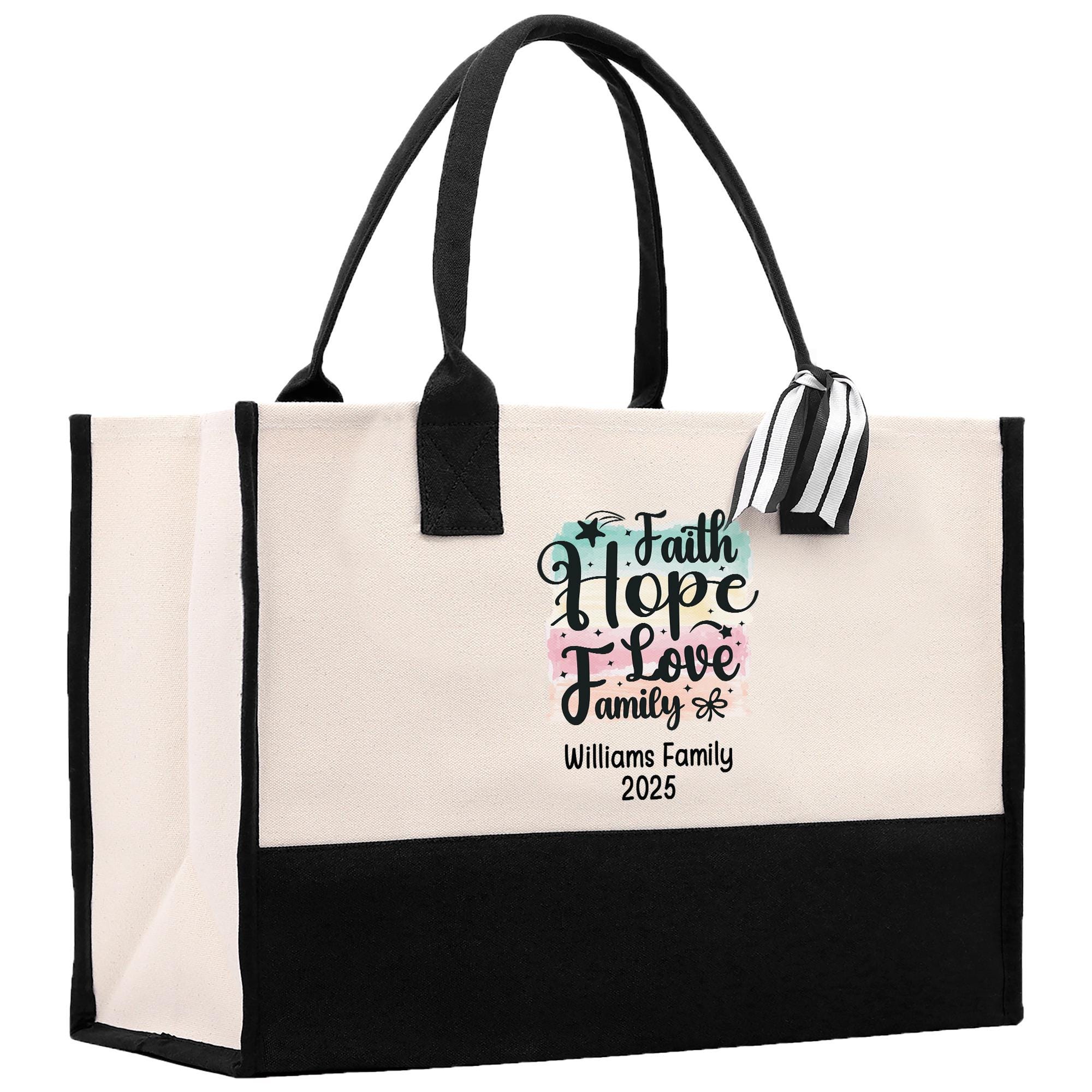 A beige tote bag with black handles and straps, featuring a printed message on the front that says &quot;Faith Hope Love Family&quot; and &quot;Williams Family 2025&quot;.