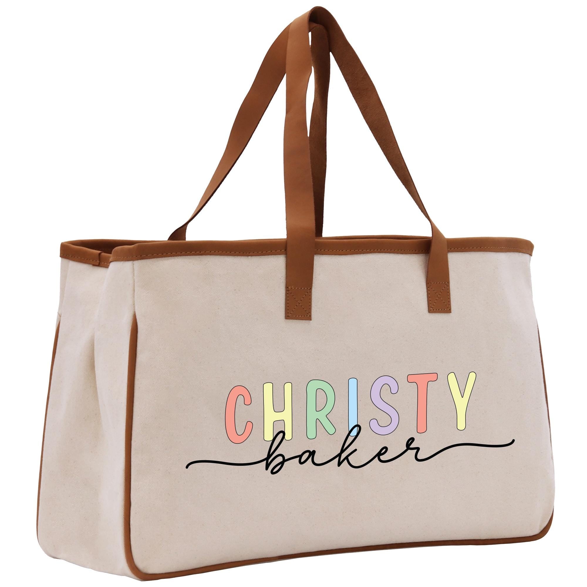 a white bag with a brown leather handle