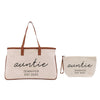 a beige tote bag and a smaller bag with the name "Auntie" printed on them.