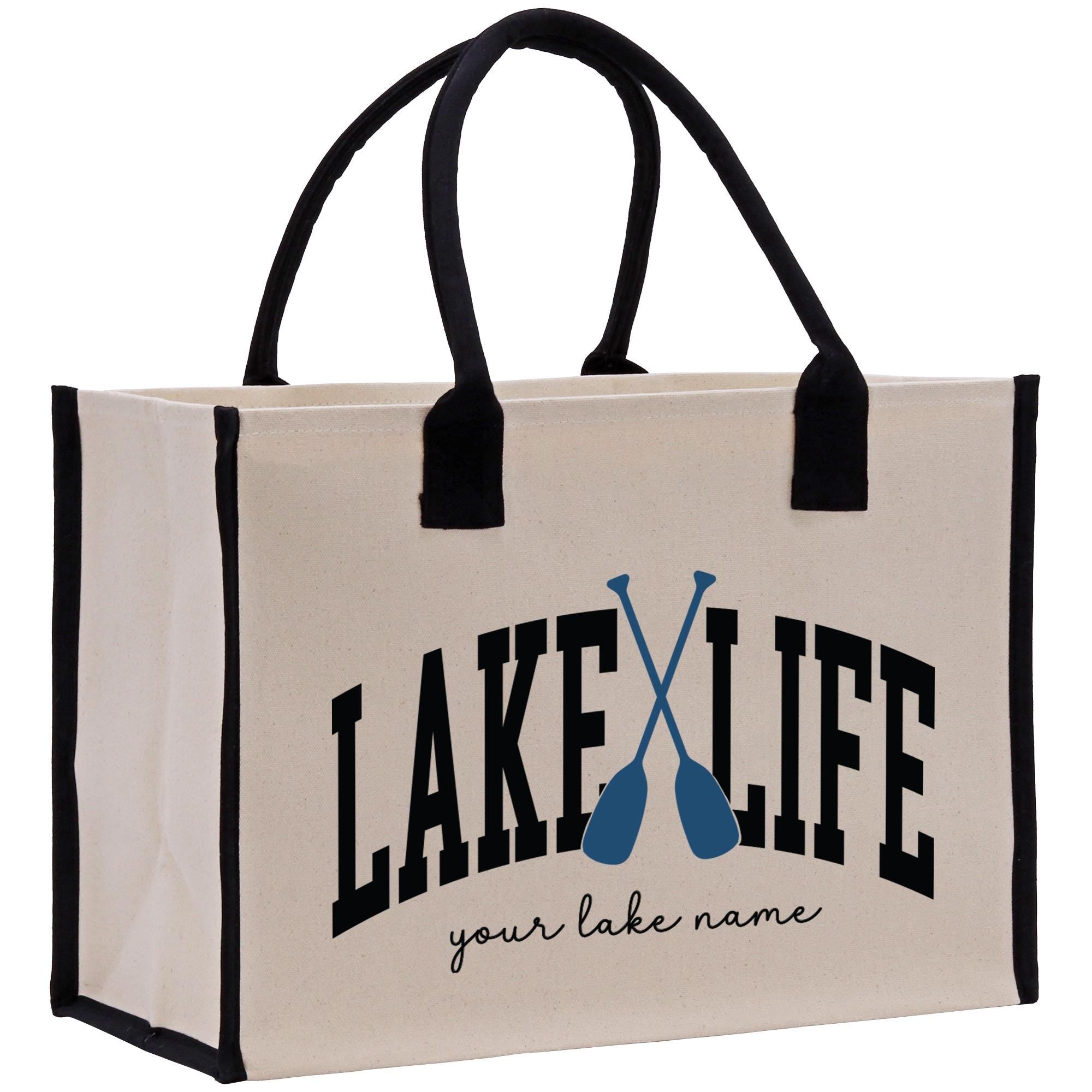 a white bag with black handles and a lake life logo on it