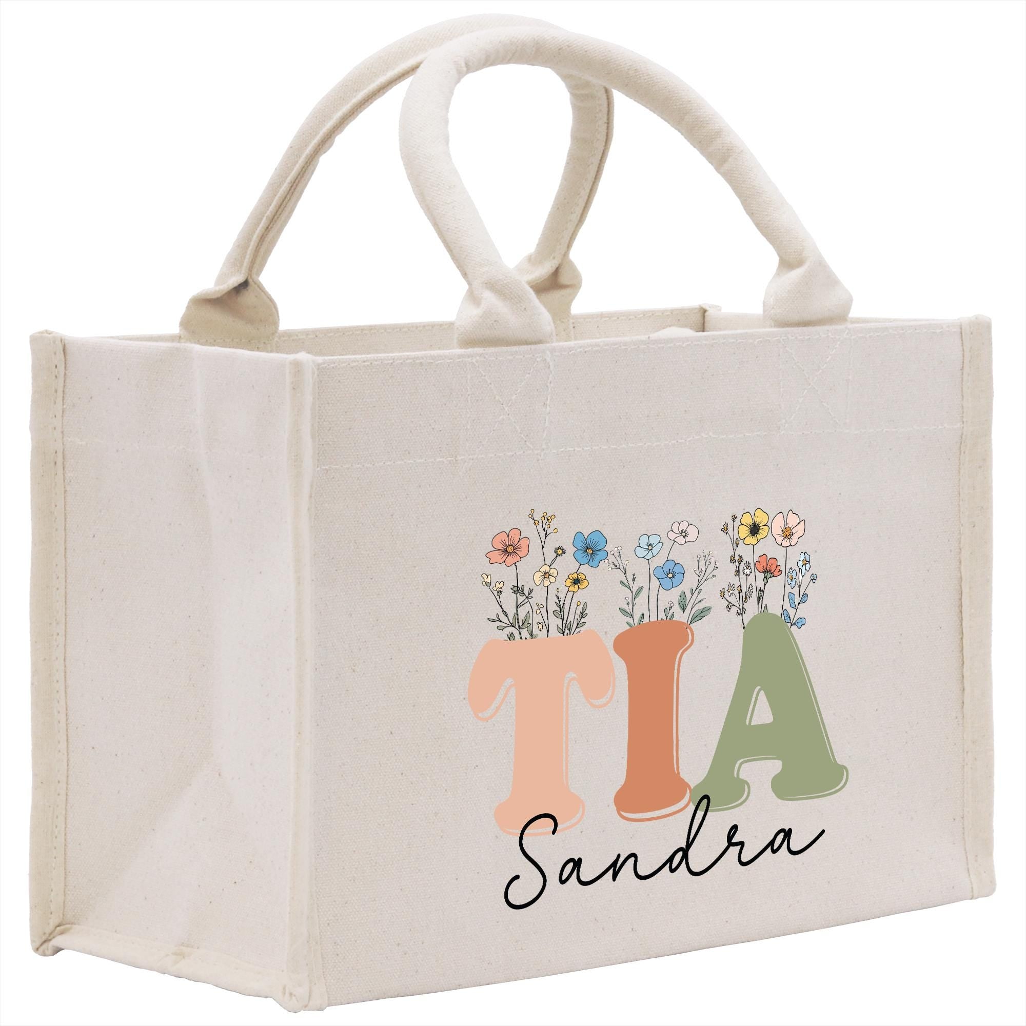 a canvas bag with the letter t a and flowers on it