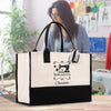 a woman holding a black and white shopping bag