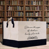 a book bag sitting on a table in front of a bookshelf