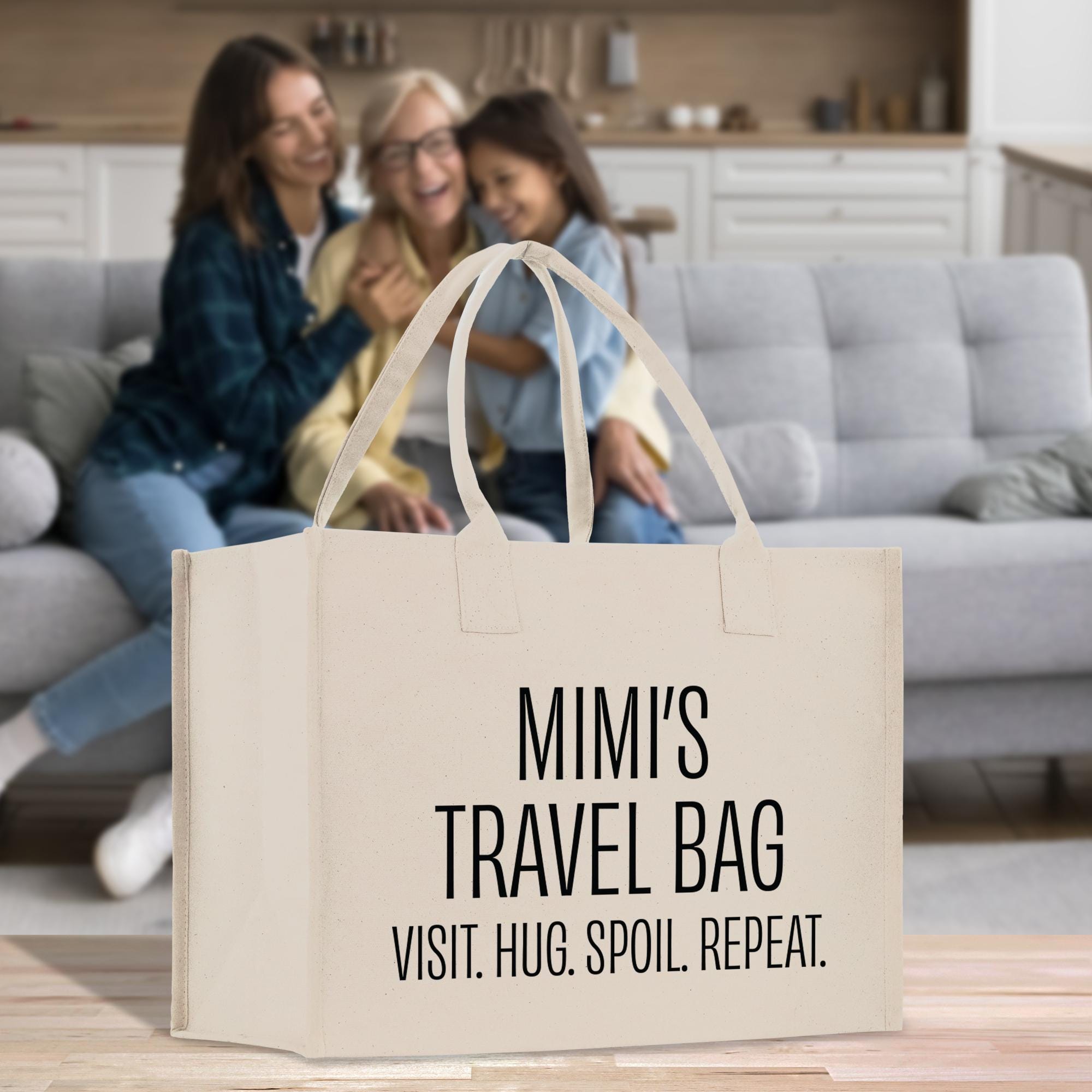 a couple of women sitting on a couch with a bag