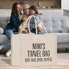 a couple of women sitting on a couch with a bag