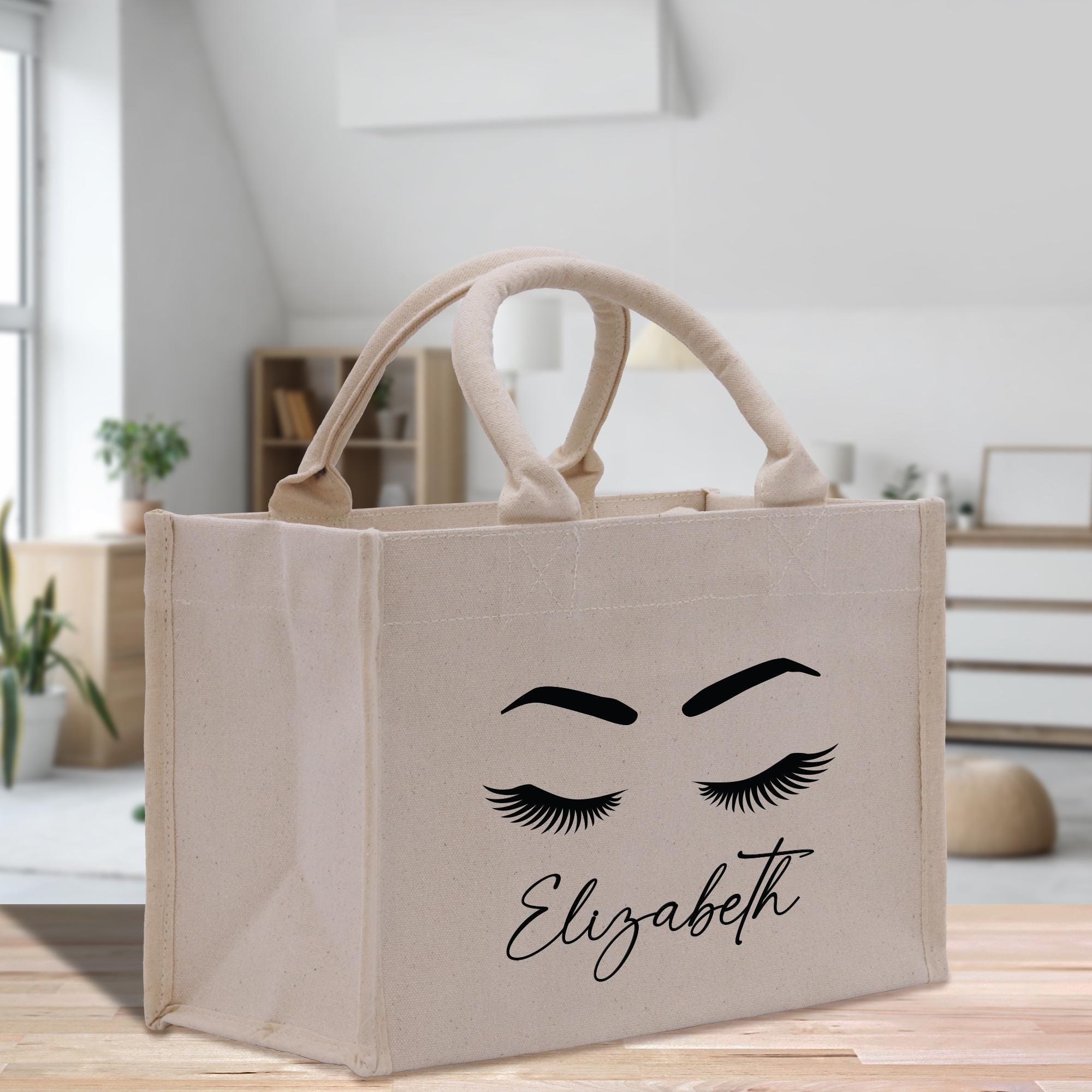 a shopping bag with eyelashes and eyelashes on it
