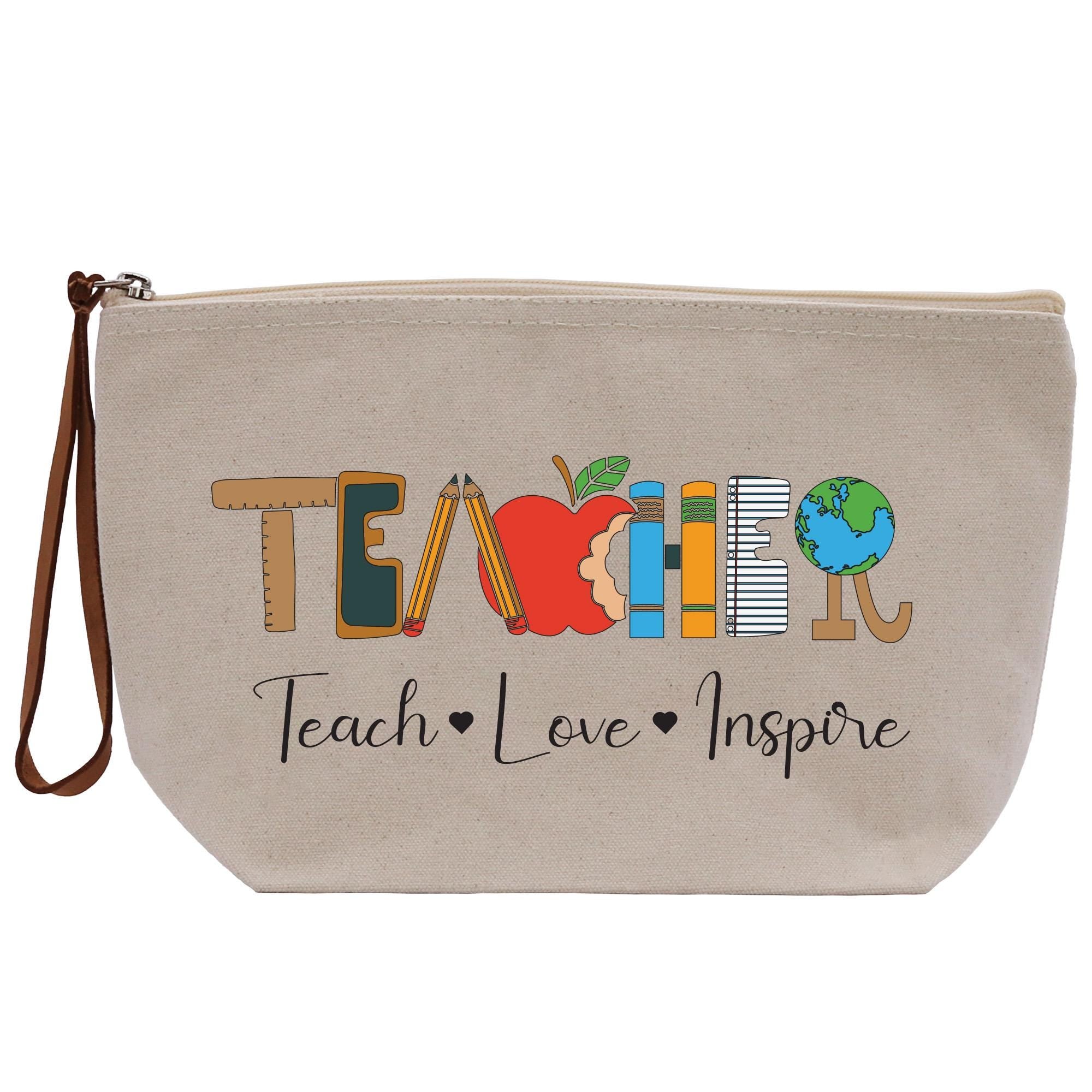 a canvas bag with the words teach and an apple on it